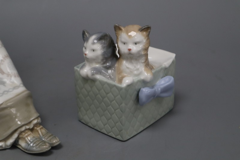 A Lladro figure of a lady sewing and a Nao group of kittens